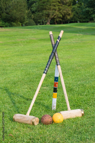 Croquet equipment propped up ready for use photo