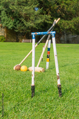 Croquet equipment propped up ready for use photo