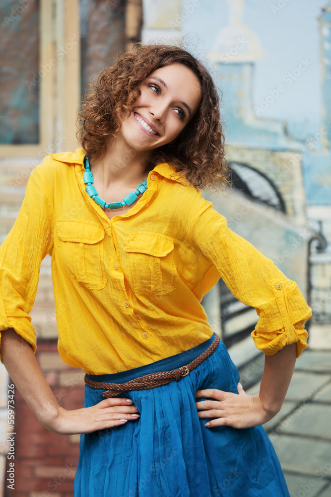 Happy young woman with curly hairs