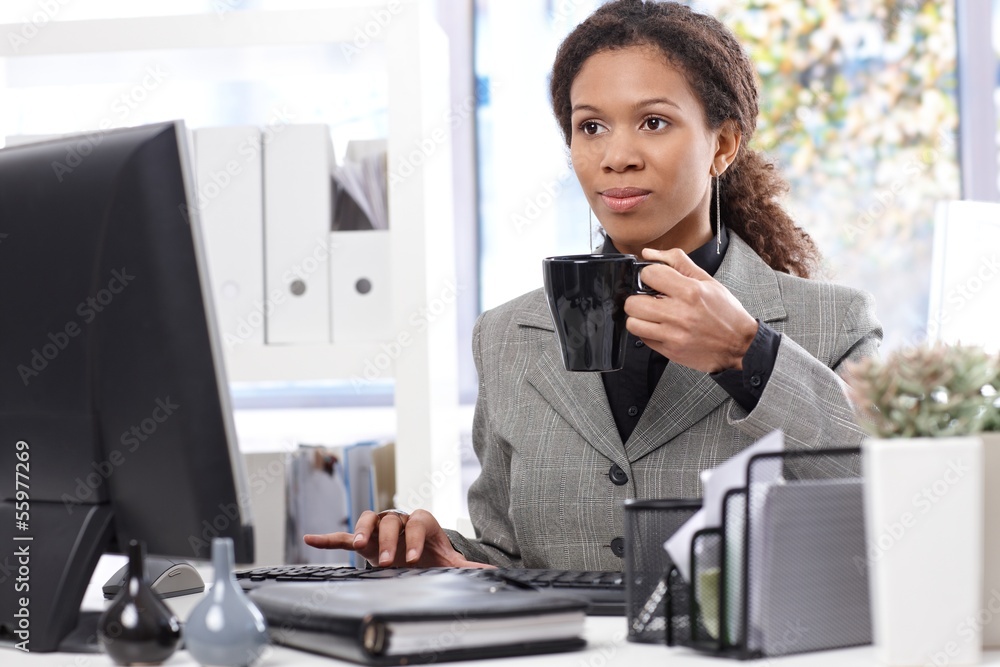 Afro businesswoman at work drinking tea Afro businesswoman at work drinking tea