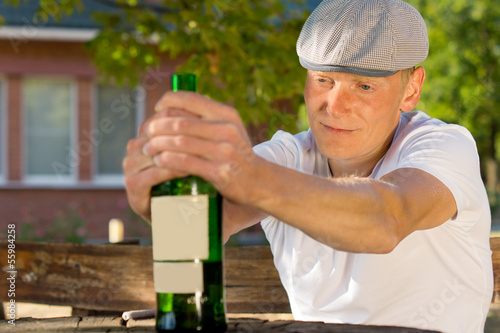 Alcoholic man feeling dizzy sitting at a table © kolotype