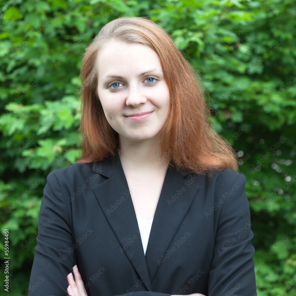 Smiling business woman in a park Smiling business woman in a park