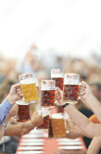 Oktoberfest beer drinkers raise glass