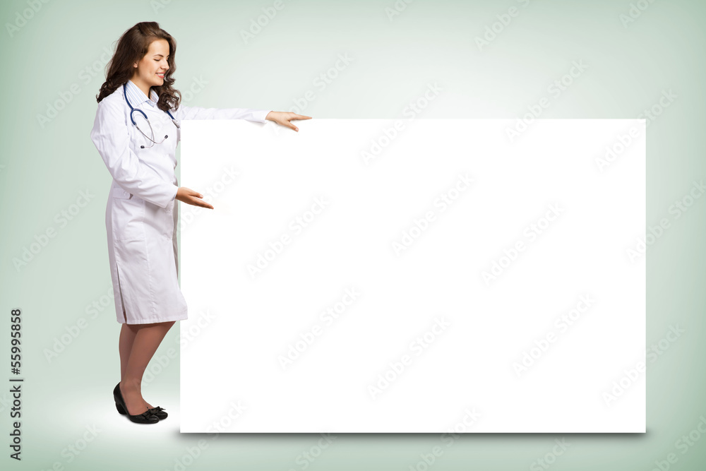 young woman doctor standing near a blank banner young woman doctor standing near a blank banner
