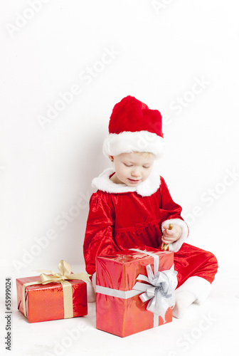 little girl as Santa Claus with Christmas presents © Richard Semik