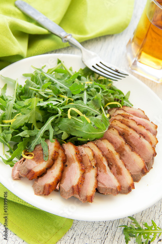 Salad with arugula and duck breast.
