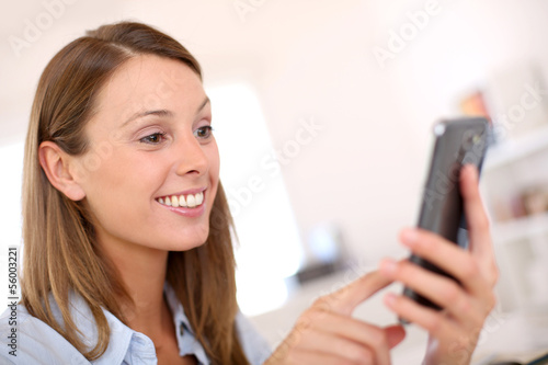 Woman in office using smartphone