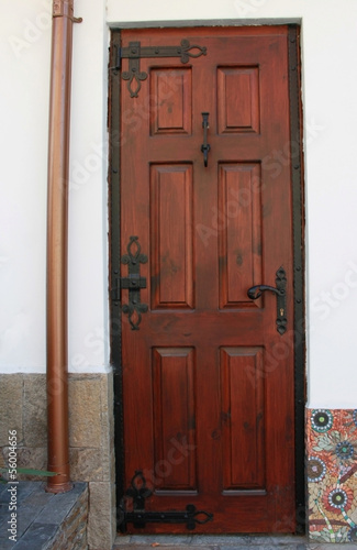 Closeup picture of wooden door with metal ornaments © dianami6ko