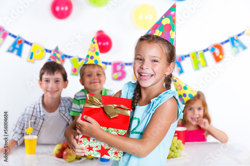 Girl with giftbox at birthday party