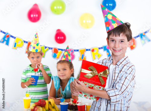 Boy with giftbox at birthday party
