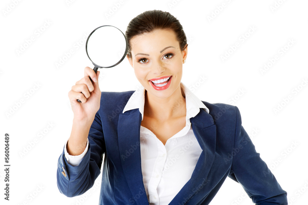 Young attractive business woman looking into a magnifying glass Young attractive business woman looking into a magnifying glass