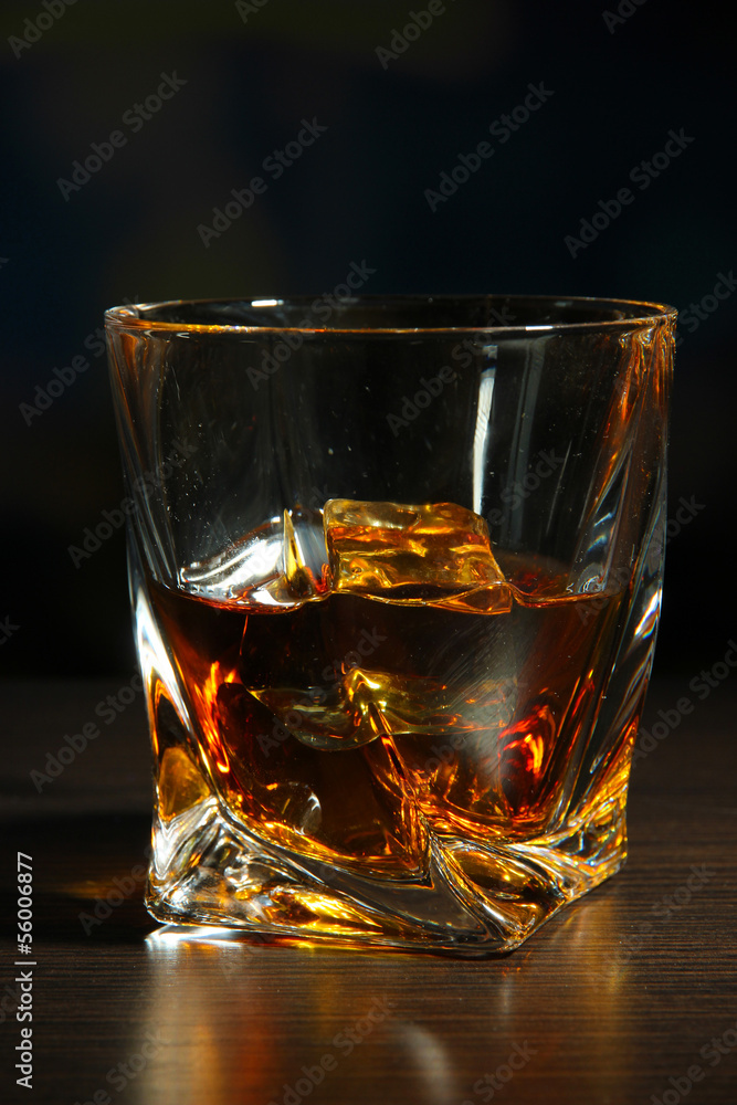 Glass of whiskey, on dark background Glass of whiskey, on dark background