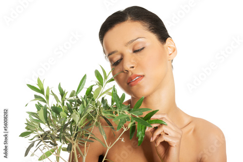 Woman with health skin and with olive tree photo