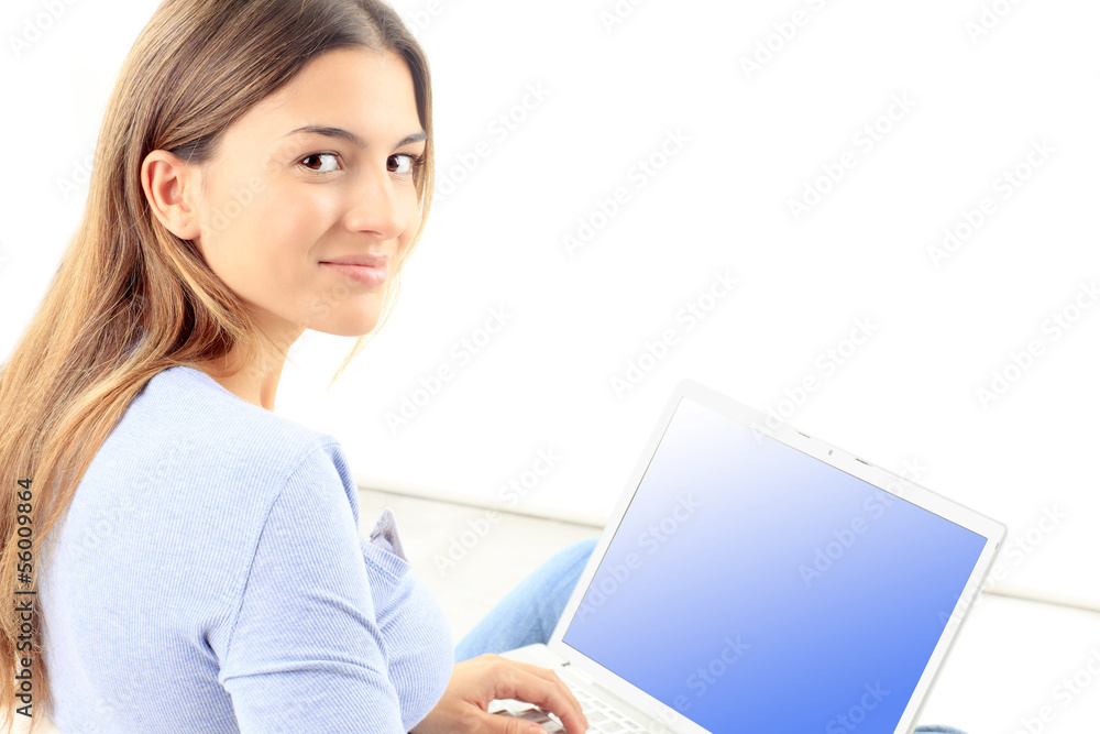 Young woman smiling while working on laptop Young woman smiling while working on laptop