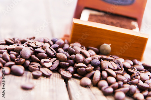 Roasted coffee beans and coffee grinder.