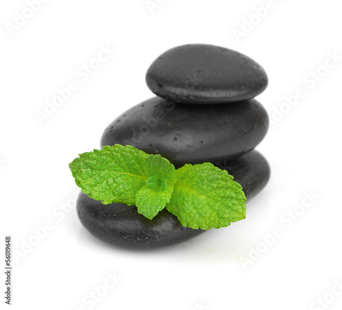 Fresh mint on the black stones with drops