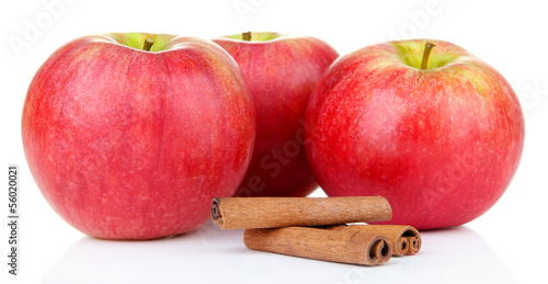 Ripe apples with with cinnamon sticks isolated on white