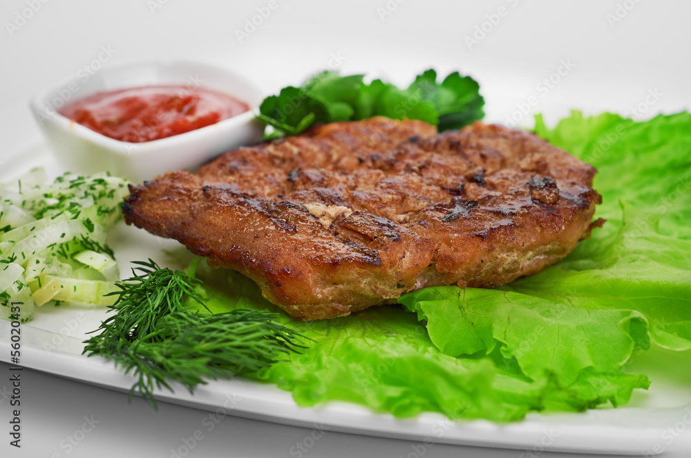 Grilled steak on a white plate