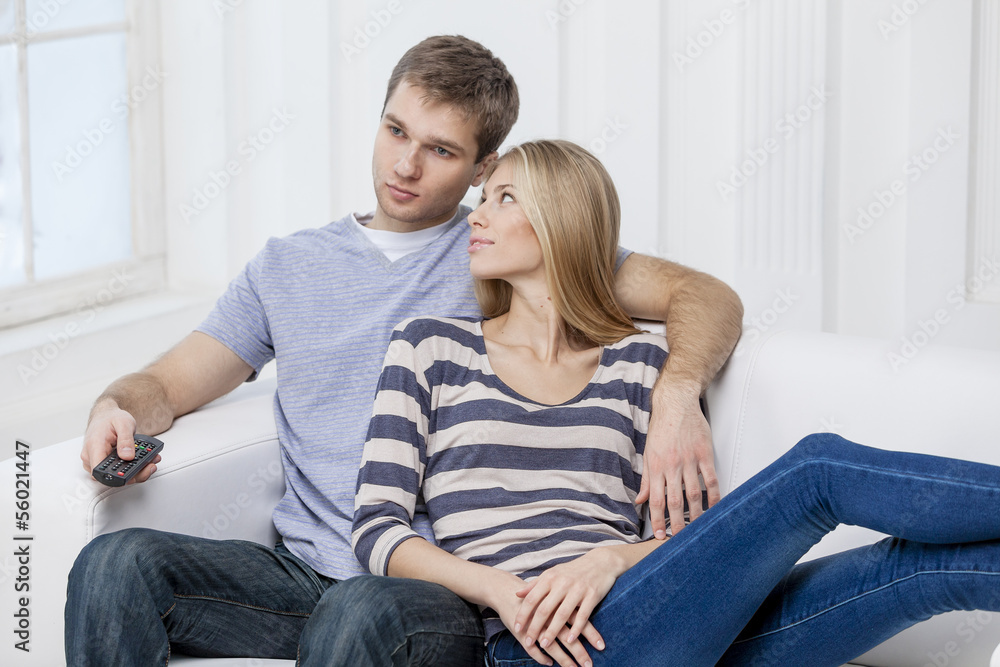young caucasian couple sitting on couch
