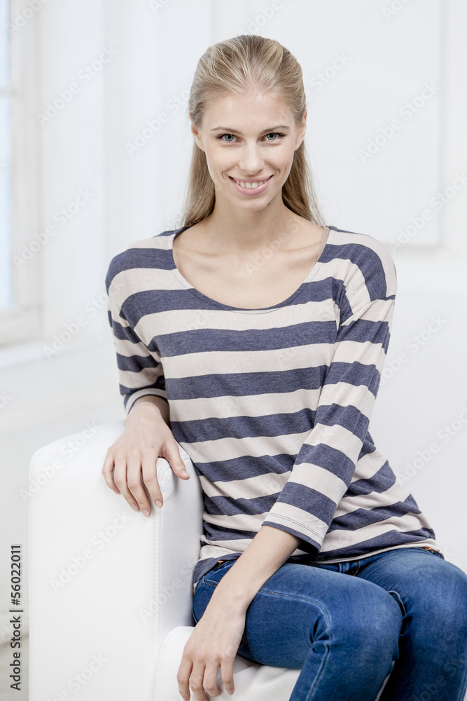 young beautiful blond woman sittin on the couch young beautiful blond woman sittin on the couch