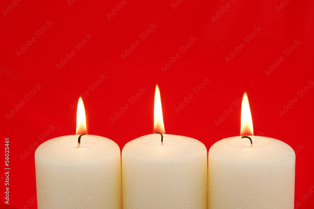 Holiday Candles with red background and copy space Holiday Candles with red background and copy space