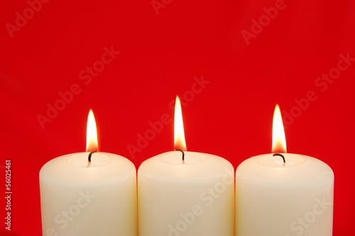 Holiday Candles with red background and copy space