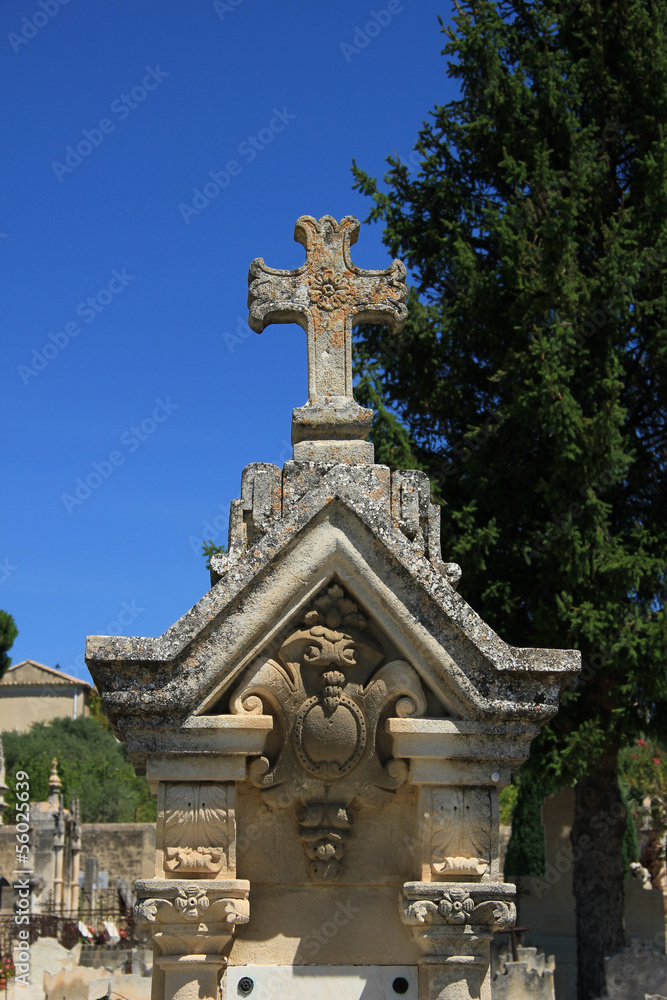 Tombstone with cross ornament at a French cemetery