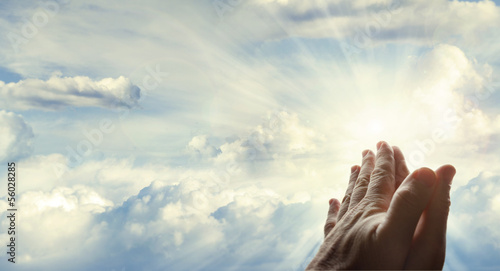 Prayer hands in heavenly sky