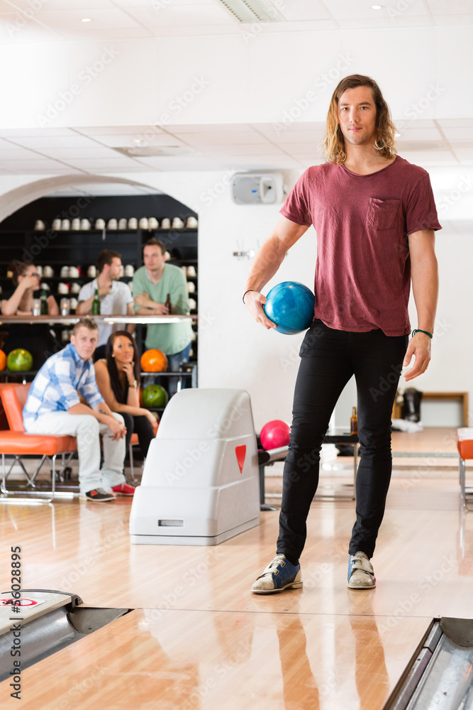 Young Man With Bowling Ball in Club