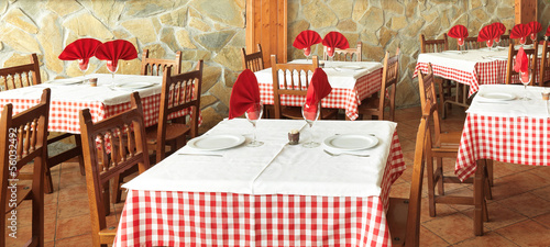 Fotografie dressed tables in an old rustic restaurant
