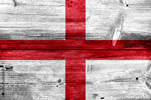 England Flag painted on old wood plank background photo