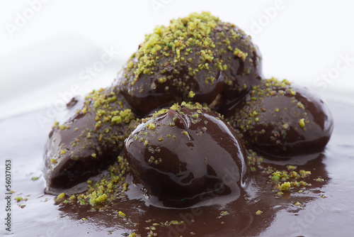 фотографія Close up of flowing down chocolate on profiterole