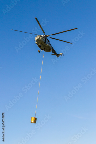 Helicopter in action carrying the water bucket.
