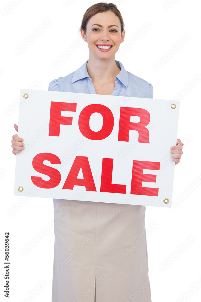 Cheerful estate agent posing with for sale sign Cheerful estate agent posing with for sale sign