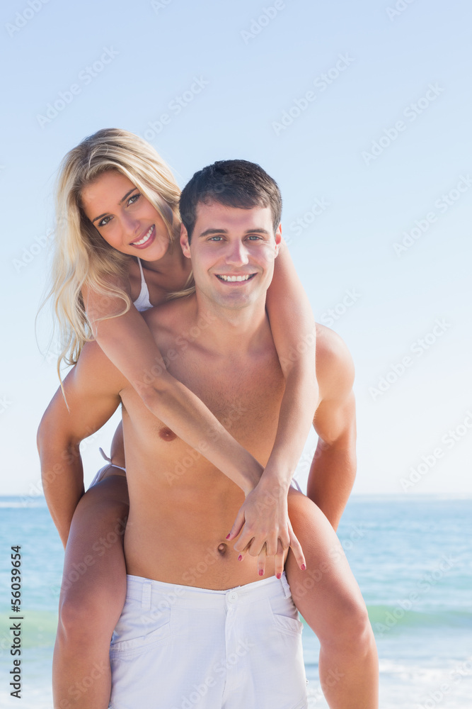 Man giving his pretty girlfriend a piggy back