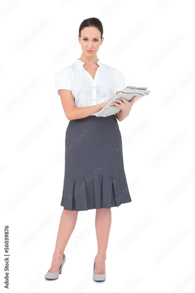 Pretty businesswoman holding newspaper Pretty businesswoman holding newspaper