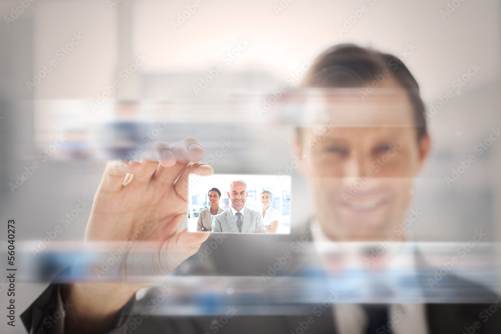 Pleased businessman presenting a picture of a business team