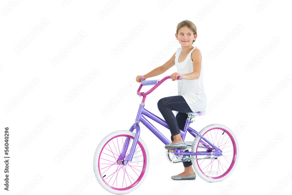 Fototapeta premium Cute young girl riding bike