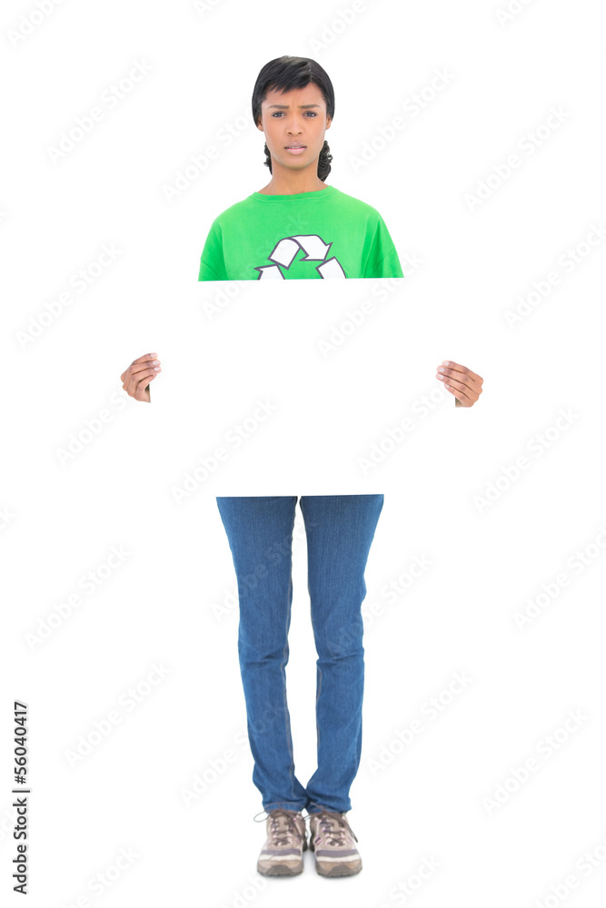 Frowning black haired ecologist holding a white panel in front o Frowning black haired ecologist holding a white panel in front o