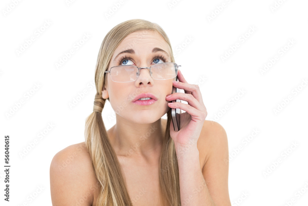 Anxious young blonde woman looking up while calling on phone Anxious young blonde woman looking up while calling on phone