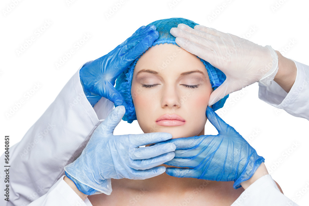 Surgeons examining peaceful blonde Surgeons examining peaceful blonde