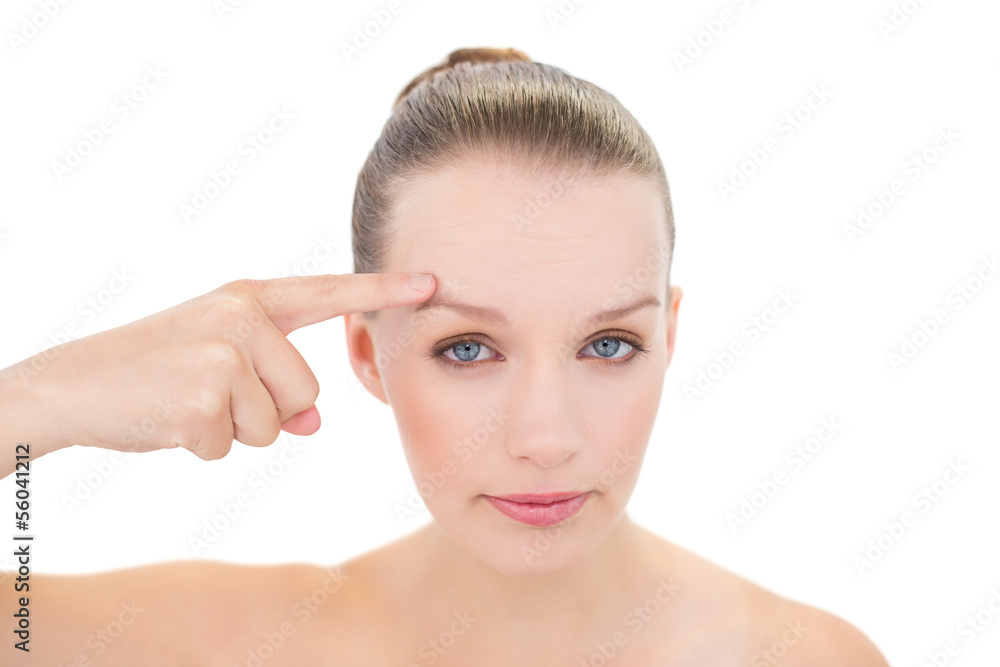 Unsmiling pretty blonde model showing her brow