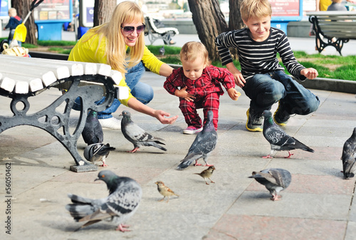 family feeding doves