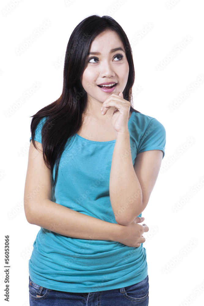 Beautiful young woman thinking and looking up Beautiful young woman thinking and looking up