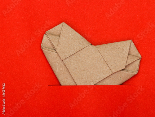 Origami recycle paper heart on red paper