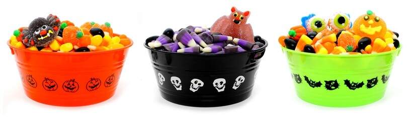 Three unique Halloween bowls filled with assorted candy