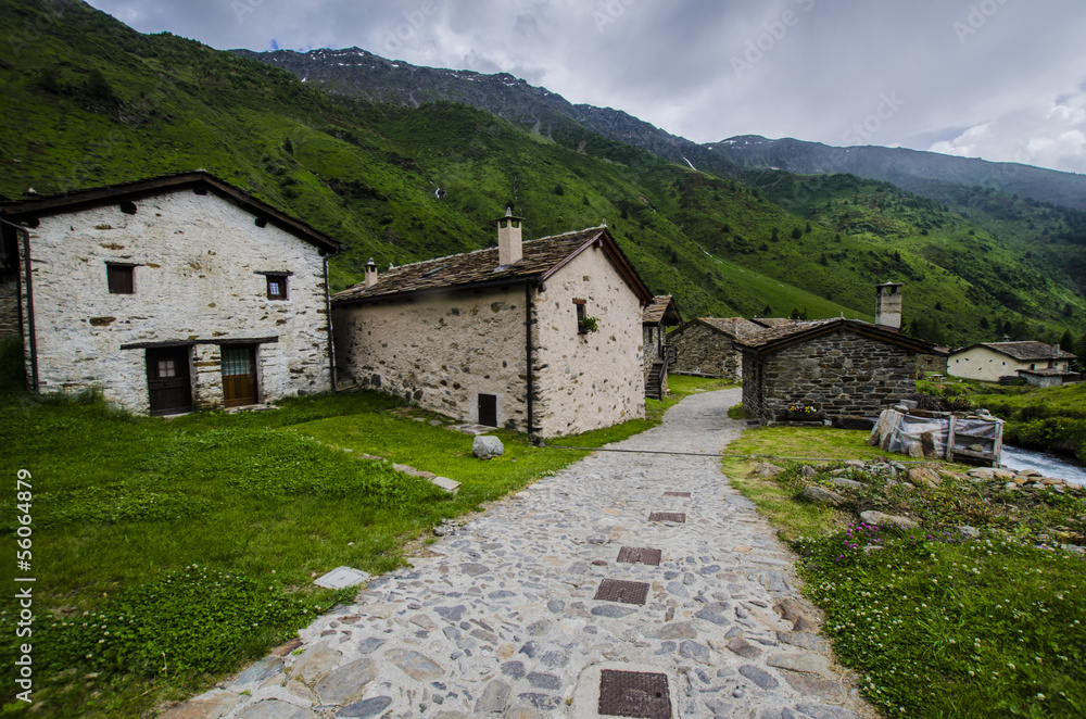 Stone shepherd's house in a peasant village in alpine meadows