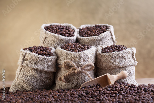 Roasted coffee beans in small burlap bags