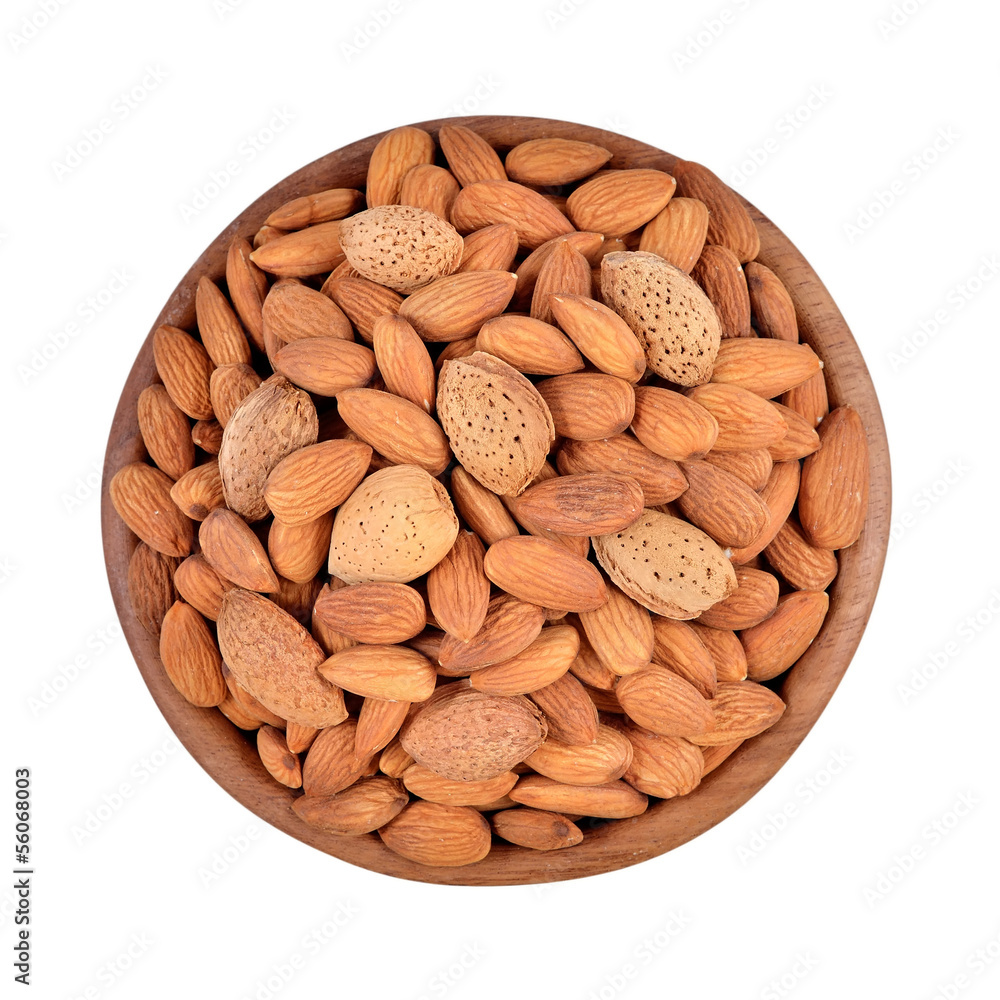 Almonds in a wooden bowl on a white background Almonds in a wooden bowl on a white background