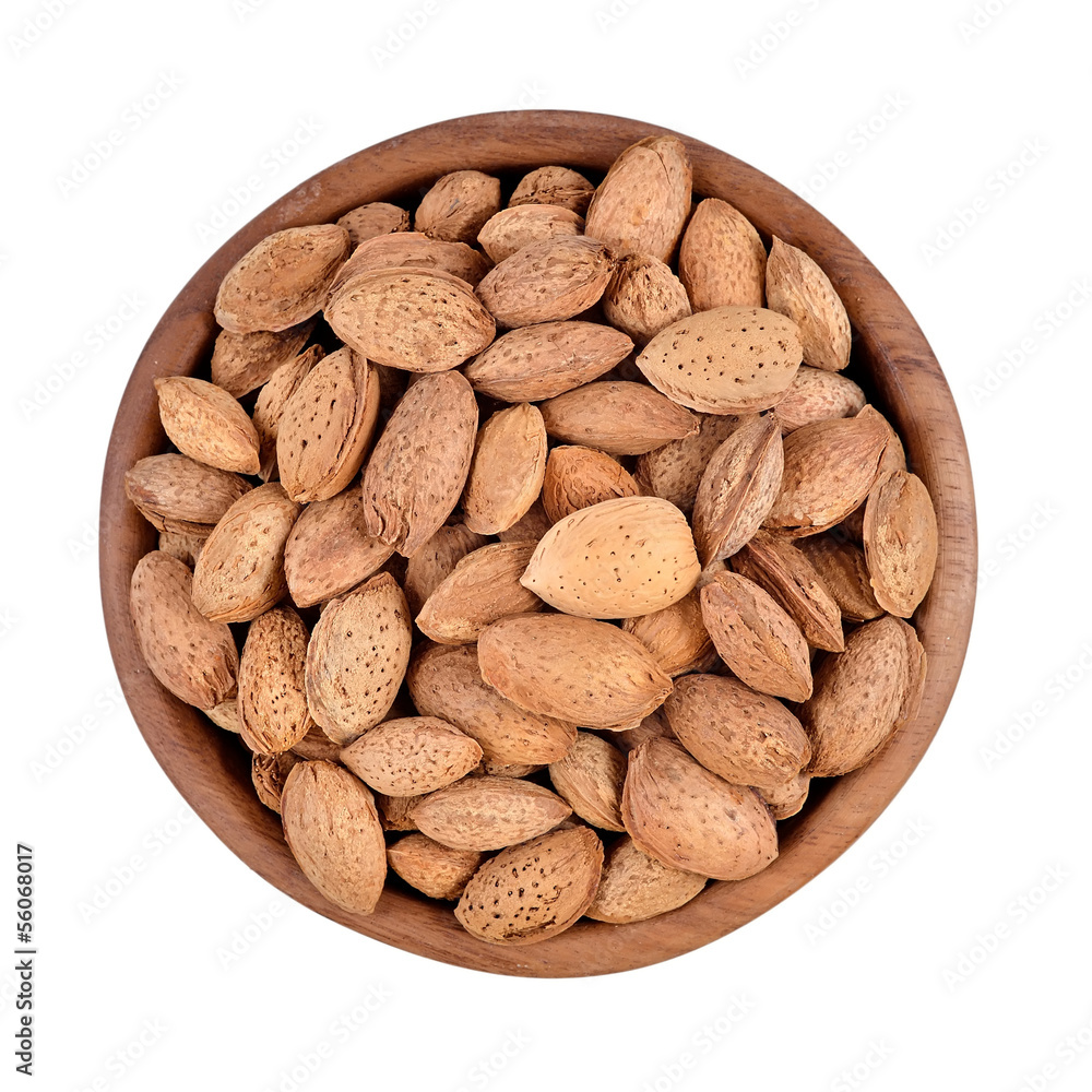 Almonds in a wooden bowl on a white background Almonds in a wooden bowl on a white background